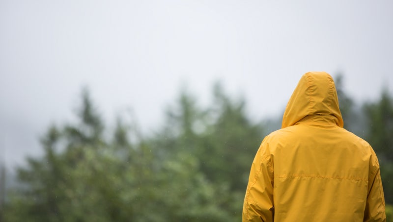 Quote from student "All of my work from the year with this ARC has prepared me to make the most out of my undergraduate career and really make a lasting impact in my community." Person with their back turned in yellow rain coat looking into the distance.